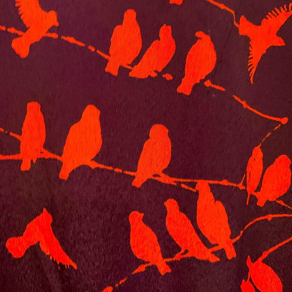 Unique purple dress with reddish orange birds.